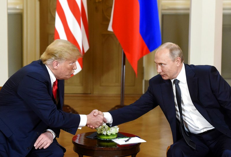 U.S. President Donald Trump, left and Russian President Vladimir Putin shake hands during their meeting Monday, July 16, 2018 in the Presidential Palace in Helsinki. Trump and Putin arrived Monday at Helsinki's presidential palace for a long-awaited summit, hours after Trump blamed the United States, and not Russian election meddling or its annexation of Crimea, for a low-point in U.S.-Russia relations. (Heikki Saukkomaa/Lehtikuva via AP)