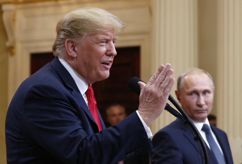 U.S. President Donald Trump speaks with Russian President Vladimir Putin during a press conference after their meeting at the Presidential Palace in Helsinki, Finland, Monday, July 16, 2018. (AP Photo/Pablo Martinez Monsivais)

