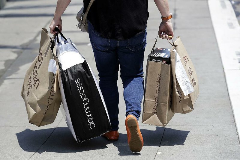 U.S. consumers, like this shopper in San Francisco earlier this month, pushed retail sales up 0.5 percent in June, the Commerce Department reported Monday.  