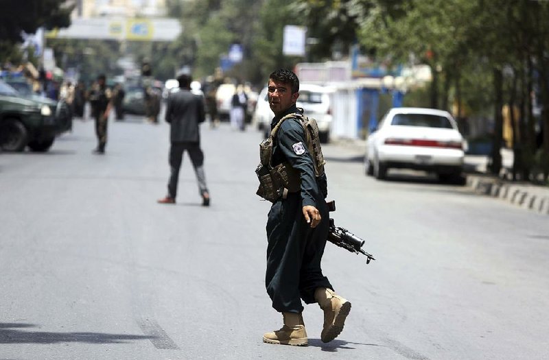 A security officer arrives at the site of a suicide attack near a park Monday in Kabul, Afghanistan. The attacker was shot and killed by police in Kabul before he was able to get close to a gathering of supporters of the country’s first vice president, Gen. Abdul Rashid Dostum, according to police spokesman Hashmat Stanekzai.  
