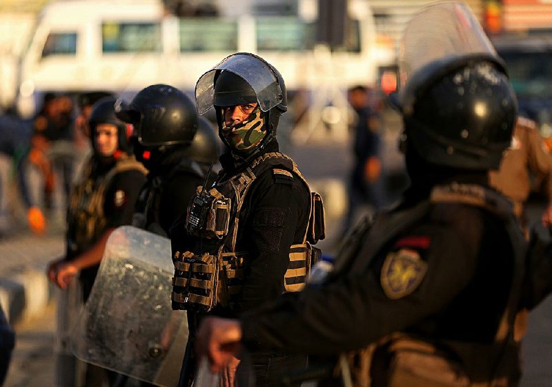 Iraqi security forces close Tahrir Square while protesters gather demanding better public services and jobs in Baghdad, Iraq, on Monday. 