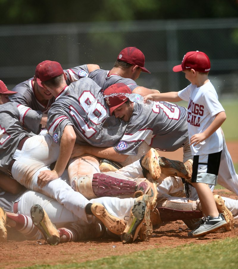 NWA Democrat-Gazette/J.T. WAMPLER The Alabama Raw Dogs celebrate beating Mid-County, Texas, Monday in the championship game of the Southwest Regional Senior Babe Ruth tournament at the White River complex in Fayetteville. The Raw Dogs won 19-3 in five innings.