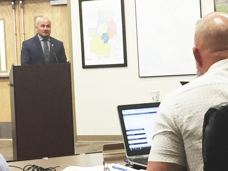 NWA Democrat-Gazette/DAVE PEROZEK Steve Vera, the Bentonville School District's safety director, addresses the School Board on Monday about a plan to give school security officers the ability to carry guns on campus if they go through prescribed training. The board approved the plan, 6-0.