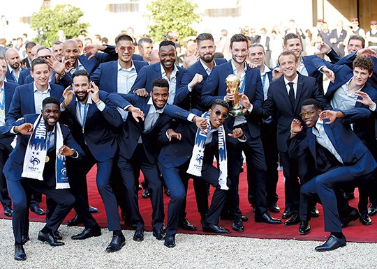 The Associated Press VIVE LA FRANCE: French President Emmanuel Macron, third right, meets with the French soccer players at the presidential Elysee Palace after the parade down the Champs-Elysees Monday to celebrate the team's 4-2 win Sunday against Croatia in the 2018 FIFA World Cup final.