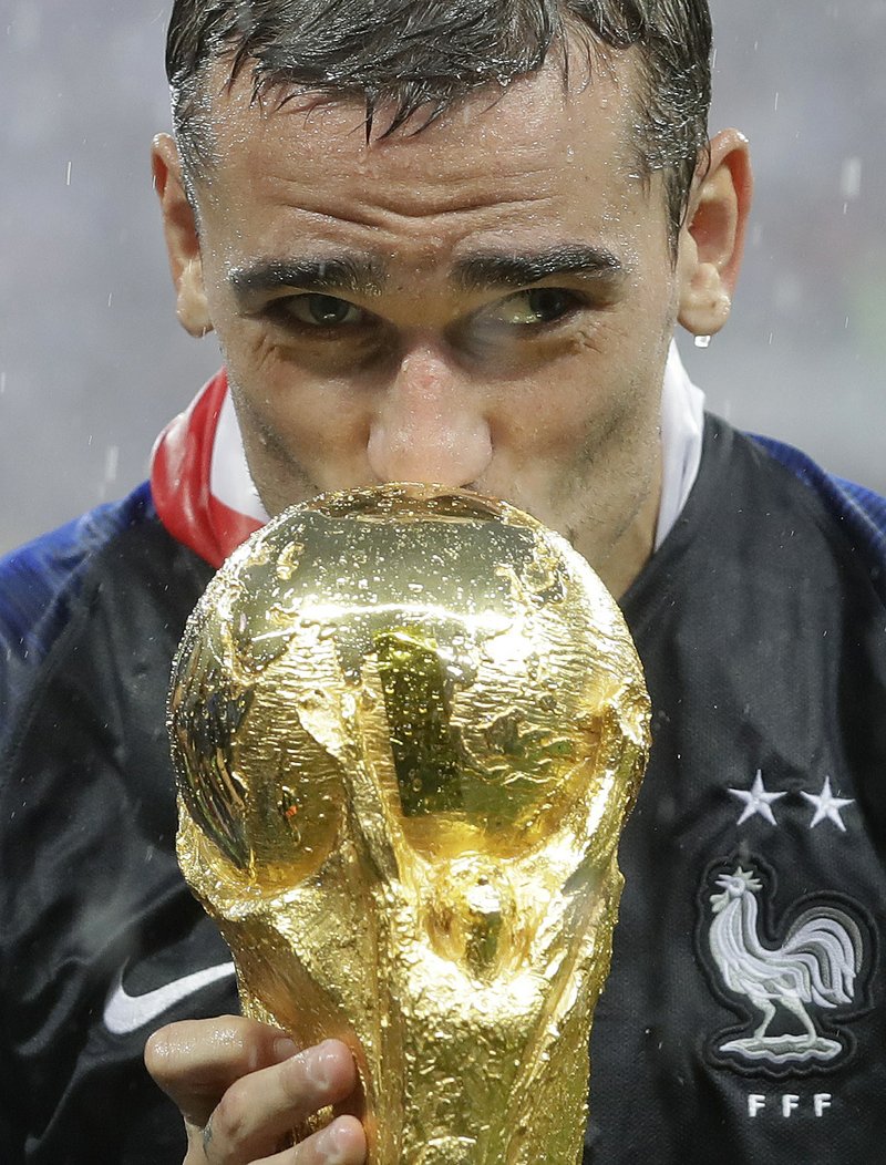 France's Antoine Griezmann kisses the trophy after the final match between France and Croatia at the 2018 soccer World Cup in the Luzhniki Stadium in Moscow, Russia, Sunday, July 15, 2018. France won the final 4-2. (AP Photo/Matthias Schrader)