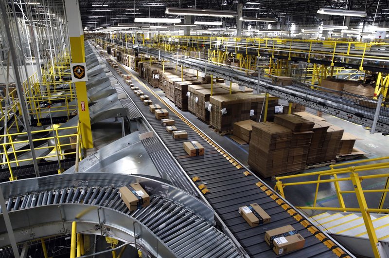 In this Aug. 3, 2017, file photo, packages ride on a conveyor system at an Amazon fulfillment center in Baltimore.  (AP Photo/Patrick Semansky, File)