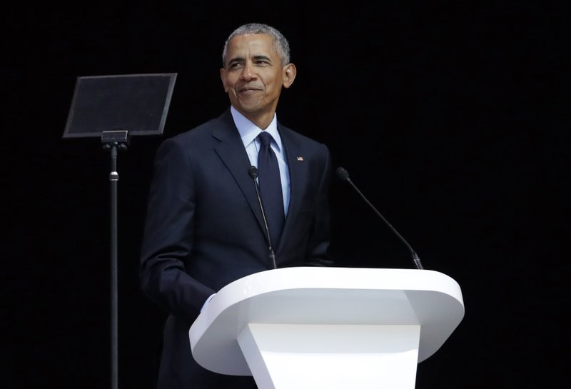 Former U.S. President Barack Obama, left, delivers his speech at the 16th Annual Nelson Mandela Lecture at the Wanderers Stadium in Johannesburg, South Africa, Tuesday, July 17, 2018.  (AP Photo/Themba Hadebe)

