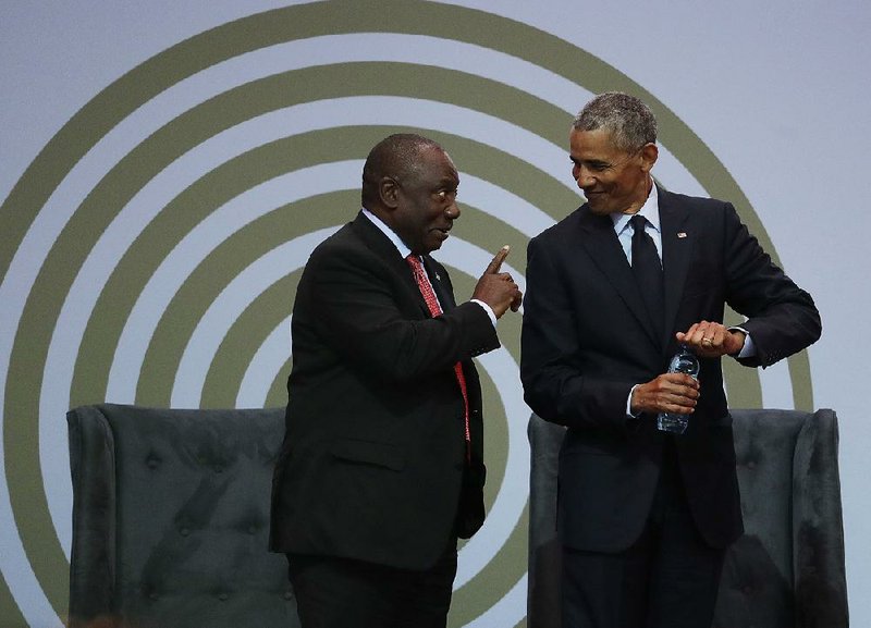 South African President Cyril Ramaphosa (left) and former U.S. President Barack Obama share a lighthearted moment Tuesday during a Johannesburg event where Obama denounced “politics of fear, resentment, retrenchment,” urging the preservation of values that he said are under threat.  