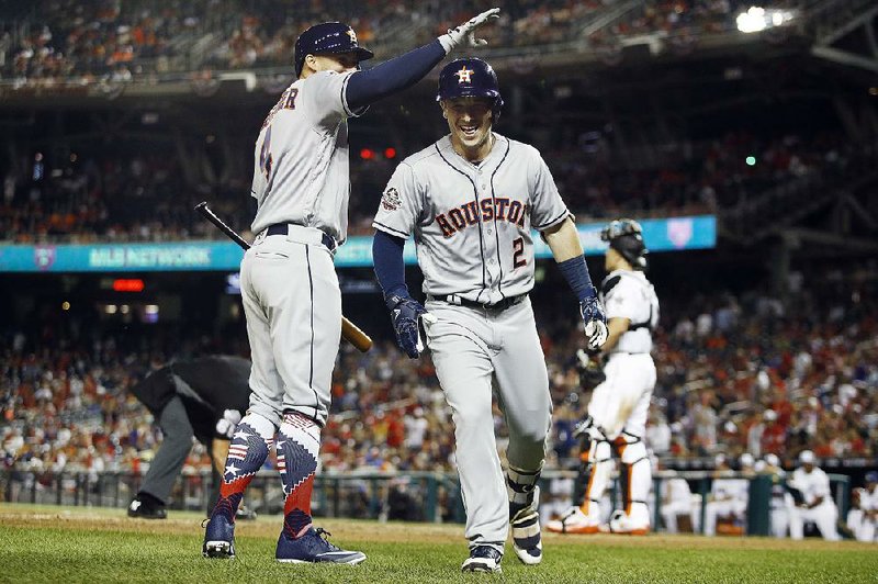 Alex Bregman (2) of the Houston Astros is congratulated by Houston teammate George Springer after his home run in the 10th inning Tuesday night gave the American League the lead in the All-Star Game. Springer followed with a home run. 