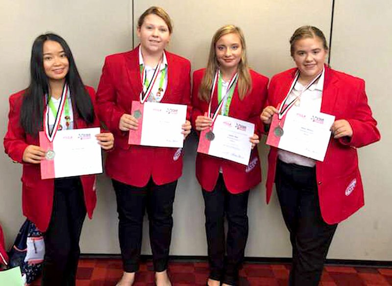 Westside Eagle Observer/SUBMITTED Members of the Decatur FCCLA show off their certificates and medals after taking a silver medal in Parliamentary Procedure competition during the national convention in Atlanta, Ga. July 2. Participating in the week-long convention were Emmy Lee, Kara Gregory, Tabby Tilley and Alisun Watson.