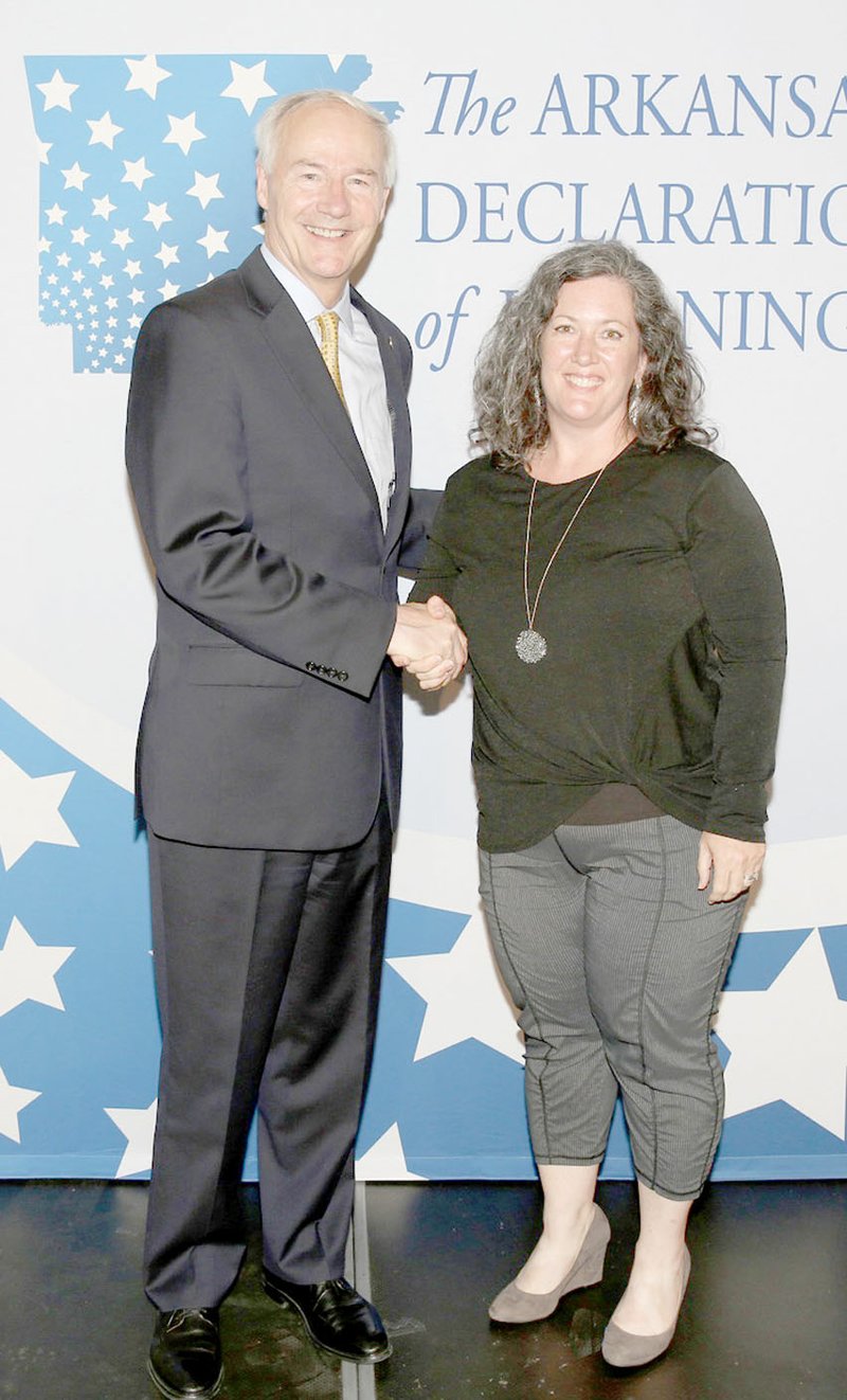 Gov. Asa Hutchinson recognizes Melanie Nations, Prairie Grove Middle School teacher, for her accomplishments with the Arkansas Declaration of Learning program.