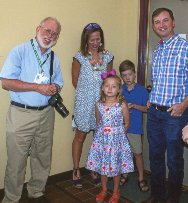 Photo by Dodie Evans Gravette dentist Arthur Evans (left) poses with the Stubbs family -- Scott Stubbs, Gentry dentist, his wife Jenna and their children, Maci and Weston. Evans retired after 47 years of practicing dentistry in Gravette. Stubbs and his partner, Alan Lamb, have purchased the practice and will soon be serving patients at the Gravette office.