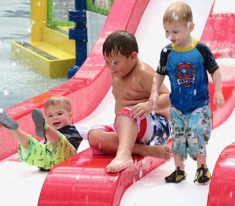 Westside Eagle Observer/RANDY MOLL These youngsters were having fun in the water on one of the water slides at the Gravette splash pad on Sunday afternoon.