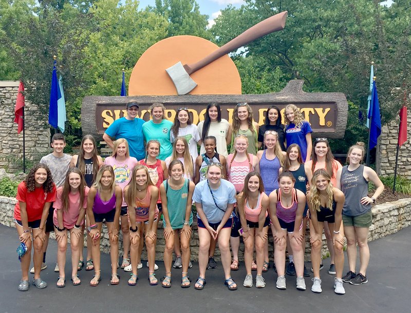 Photo submitted Members of the Siloam Springs High School volleyball team pose for a picture in front of the giant ax at the entrance to Silver Dollar City theme park near Branson, Mo. The Lady Panthers spent last week in Branson competing at Licking Team Camp.
