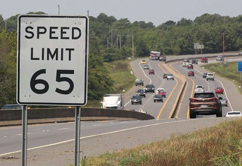 The Sentinel-Record/Richard Rasmussen OBEY THE SIGN: Motorists drive along the King Expressway Tuesday near one of the posted speed limit signs. As part of a statewide speed mobilization with the slogan, "Obey the Sign or Pay the Fine," Hot Springs police and Garland County sheriff's deputies are working areas known for excessive speeds. Police issued 28 speeding tickets on Monday on the expressway.