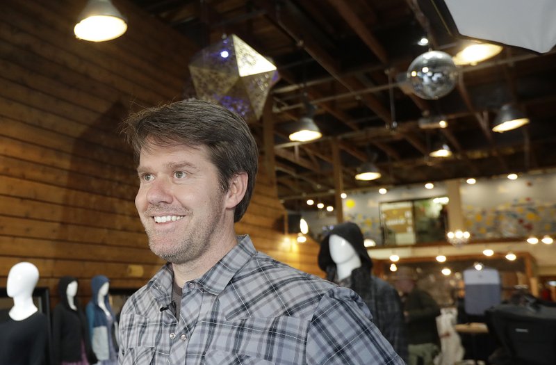 In this Feb. 15, 2018 photo, Betabrand CEO Chris Lindland smiles while interviewed at a Betabrand store in San Francisco. Betabrand represents one of the most dramatic examples of how companies _ big and small _ are starting to use digital technology to reinvent and speed up-the process of designing and selling clothing to shoppers in the age of Amazon. (AP Photo/Jeff Chiu)