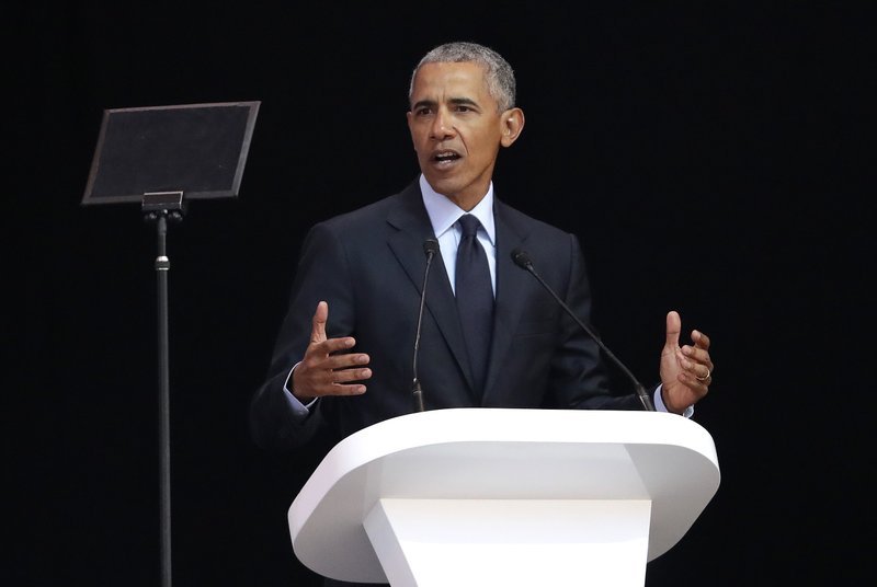 Former U.S. President Barack Obama, left, delivers his speech at the 16th Annual Nelson Mandela Lecture at the Wanderers Stadium in Johannesburg, South Africa, Tuesday, July 17, 2018. In his highest-profile speech since leaving office, Obama urged people around the world to respect human rights and other values under threat in an address marking the 100th anniversary of anti-apartheid leader Nelson Mandela's birth. (AP Photo/Themba Hadebe)