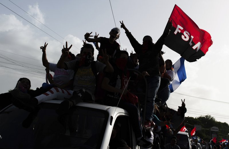 Sandinista supporters of President Daniel Ortega wait for his arrival in Masaya, Nicaragua, Friday, July 13, 2018. According to human rights groups, more than 300 person have been killed since April 19, since demonstrations erupted against the government of President Ortega. Most of them opponents of the regime. (AP Photo/Cristobal Venegas)