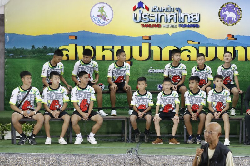 Members of the rescued soccer team and their coach sit during a press conference discussing their ordeal in the cave in Chiang Rai, northern Thailand, Wednesday, July 18, 2018. The 12 boys and their soccer coach rescued after being trapped in a flooded cave in northern Thailand are recovering well and are eager to eat their favorite comfort foods after their expected discharge from a hospital soon. (AP Photo/Vincent Thian)

