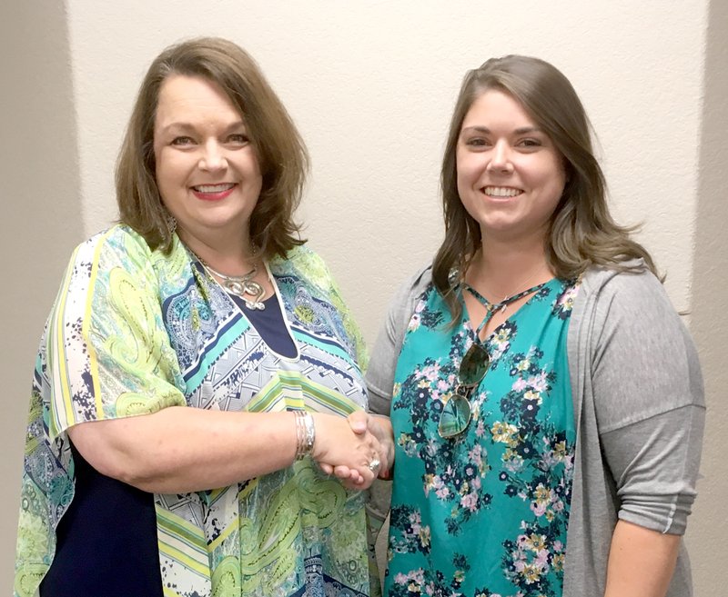 After administering the oath of office on July 10, Highfill Mayor Michelle Rieff (left) shakes hands with new council member Jayme Thompson to welcome her to the Highfill City Council. Thompson was appointed by the council on July 10 to fill the vacant Ward 1, Position 1, seat on the council.