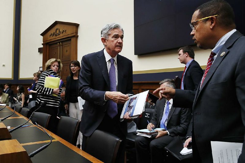 Federal Reserve Board Chairman Jerome Powell (left) speaks Wednesday with Rep. Keith Ellison, D-Minn., during a break in Powell’s testimony before the House Committee on Financial Services in Washington.  