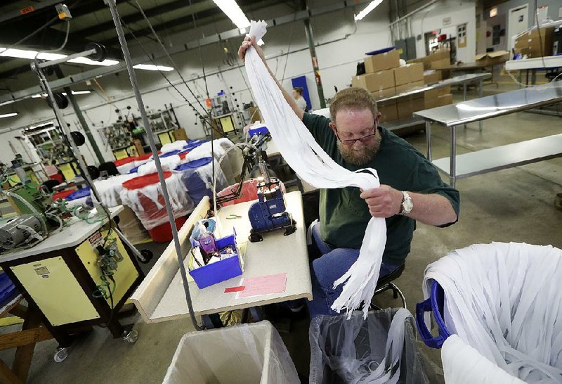 Barry Brown works earlier this year at Dunlap Industries, a small zipper-making company that is fi ghting to keep its pared-down staff occupied after losing its U.S. military-uniforms contract.  
