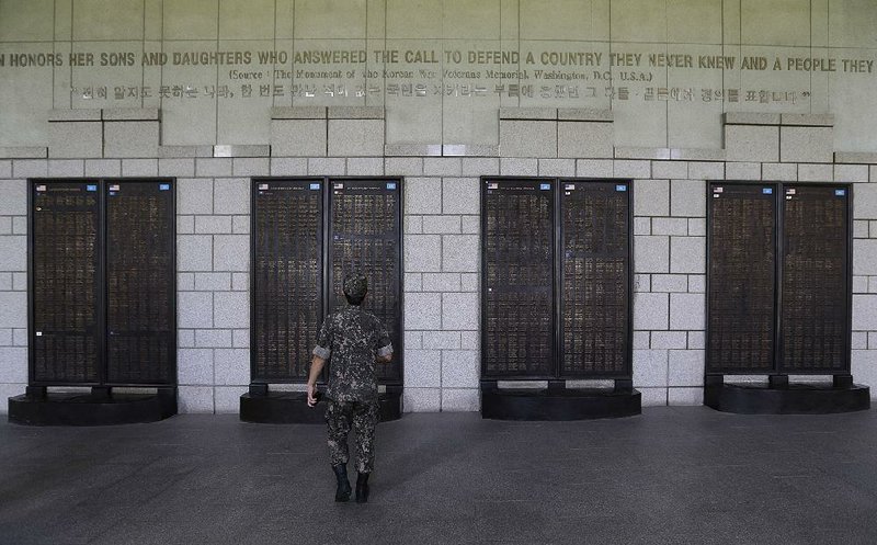 A South Korean soldier at the Korea War Memorial Museum in Seoul looks Sunday at the list of the U.S. soldiers who were killed in the conflict. 