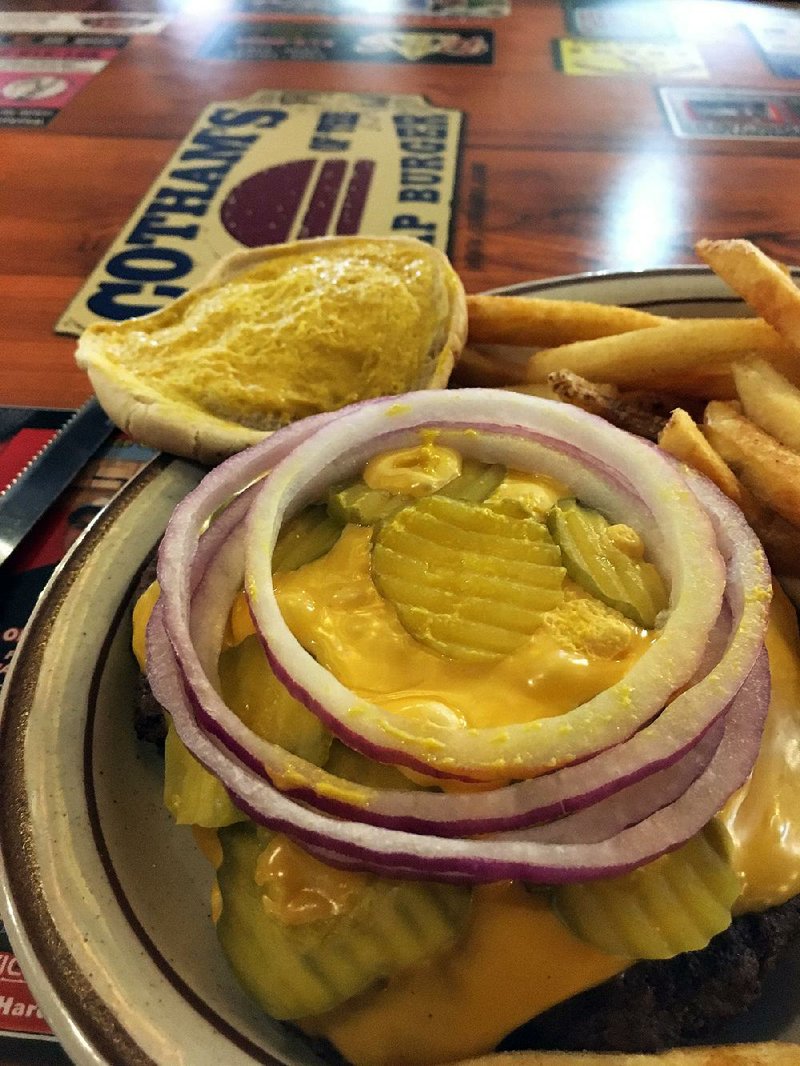 The Hubcap Cheeseburger, minus the lettuce and tomato, comes with a plentiful pile of fries at Cotham’s in the City. 