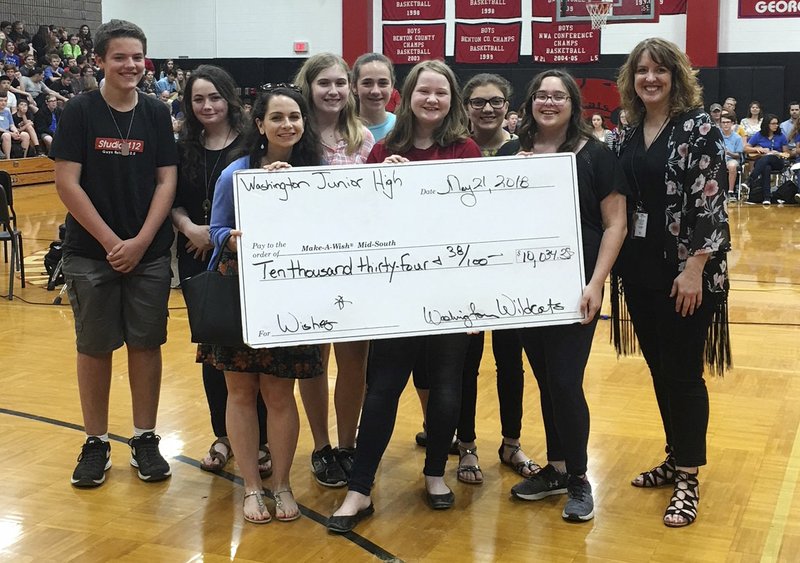 Courtesy photo Members of the Children's Hospital Club at Washington Junior High School in Bentonville ended the school year by presenting the Make a Wish Foundation with $10,034. Participating were (first row, from left) Esther Schroeder from Make a Wish, Halle Jenkins, Sophia Fargo, school choir director Shelly O'Dell, Cooper Pattengill, (back row) Blake Johnson, Victoria Stevens, Rachel Gregory and Alexa Roldan. The students, staff, clubs and classrooms at the school participated in several fundraisers throughout the year.