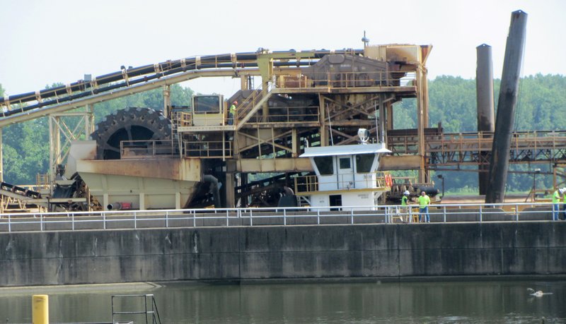 Arkansas Democrat-Gazette/DAVE HUGHES
A towboat prepares to pull Arkhola Sand & Gravel’s dredge barge from Lock and Dam 13 at Barling after one of four spuds that are lowered into the river to anchor the barge, standing askew at right, struck the underside of the Arkansas 59 bridge Thursday morning. The bridge was closed to traffic for about two hours and was reopened after Arkansas Department of Transportation engineers inspected the bridge.
                               