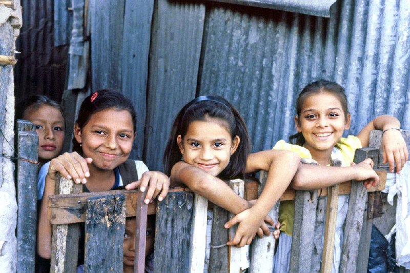 Taking an educational tour often means you’ll visit a struggling part of the world and engage with the locals — like these schoolchildren in El Salvador. 