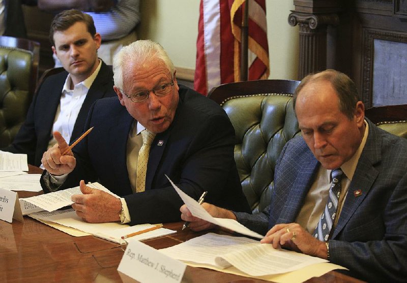 Republican Reps. Austin McCollum of Bentonville (from left), John Eubanks of Paris and Johnny Rye of Trumann participate in Thursday’s hearing with the medical marijuana commission at the state Capitol.  