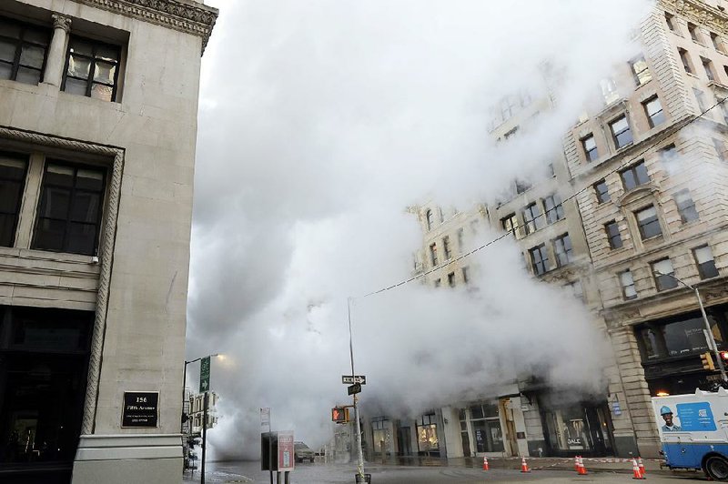 Steam from a burst asbestos-lined pipe envelopes part of New York’s Fifth Avenue early Thursday.  