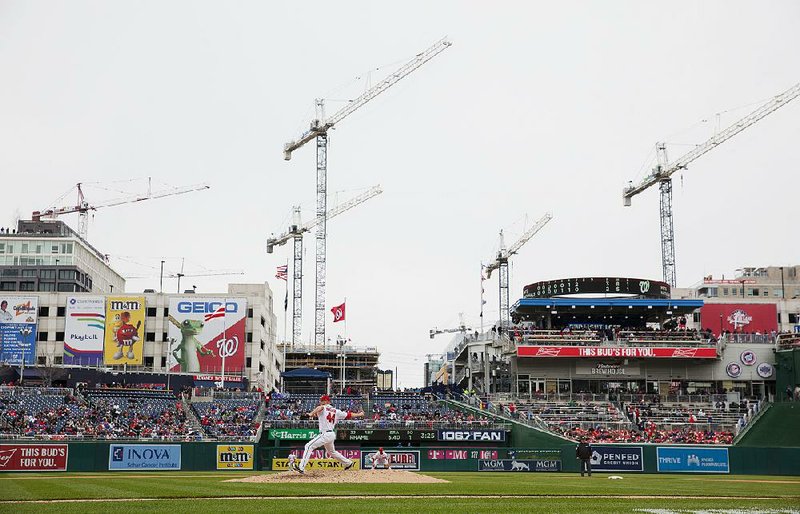 Construction cranes tower over Nationals Park in Washington during a game earlier this year between the Washington Nationals and New York Mets. Seattle is leading the nation again this year in the number of construction cranes.  
