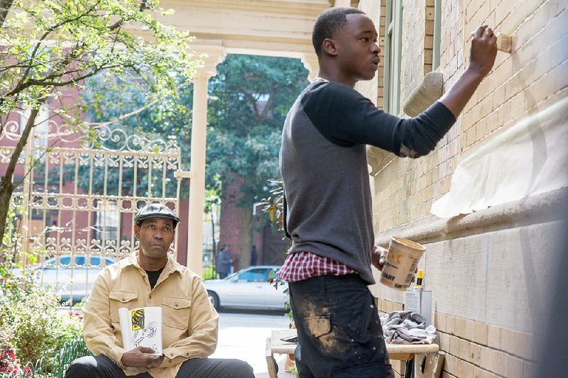 Aspiring artist Miles (Moonlight star Ashton Sanders) works on a mural as his mentor Robert McCall (Denzel Washington) looks on in Antoine Fuqua’s The Equalizer 2. 
