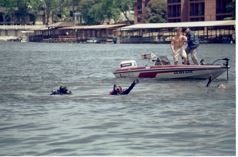 FILE — Two divers wave to signal that they have victims in their grasp at the scene of the sunken Duck boat on Lake Hamilton Saturday, May 1, 1999.