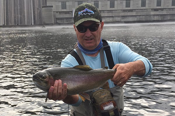 In this file photo Clay Henry holds a 27-inch rainbow trout below Bull Shoals Dam.