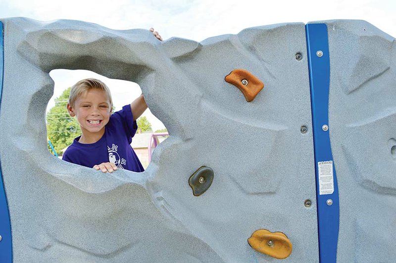 Jay Lemieux, 8, plays on one of the playgrounds Marguerite Vann Elementary School in Conway. The school was selected as one of 24 in Arkansas for a pilot program for extended recess. Instead of 30 minutes a day for students in kindergarten through the fourth grade, the students will get 60 minutes a day. Principal Bobby Walker said research shows that students allowed to play come back ready to focus.