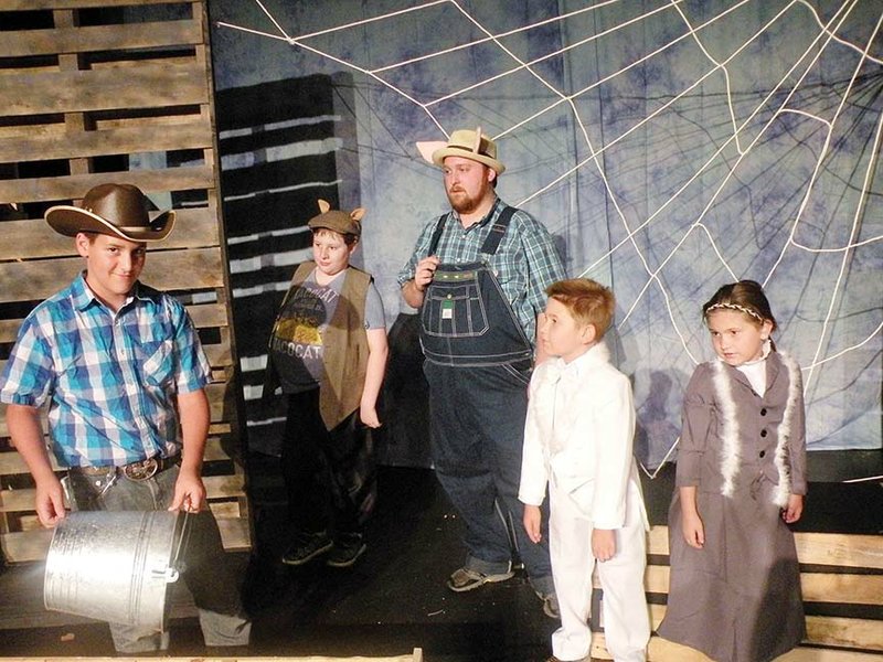 Lurvy, played by Dakota Driver, far left, prepares to feed Wilbur the pig in this scene from Charlotte’s Web, which will be presented by the Rialto Players. Looking on are some of Wilbur’s animal friends — back row, from left, Templeton the rat, played by Isaac Goodrich; Uncle, the large pig that lives near Wilbur at the county fair, played by A.J. Finley; Gander, played by Jason Swain; and Goose, played by Jayden Swain.