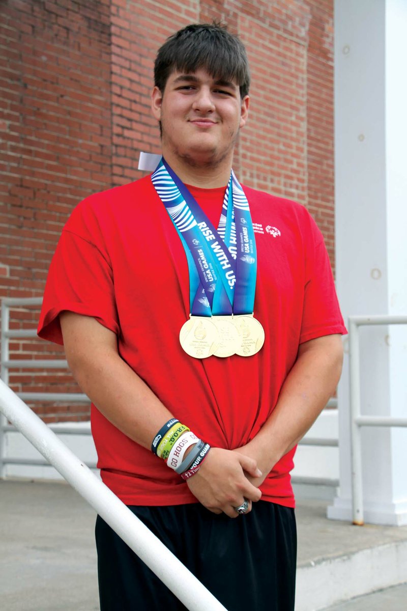 Alex Smith of Hensley shows off the three gold medals he recently won at the Special Olympics in Seattle. 