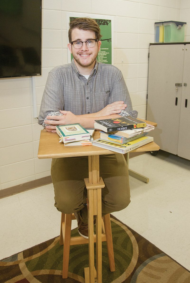 Russell Denette sits at a lectern he made for his Mayflower High School classroom, where he teaches English and journalism. Denette, 28, is the licensed Employee of the Year for the high school. One of his former students, Millennia Williams, said Denette is a “great mentor as well as teacher.”