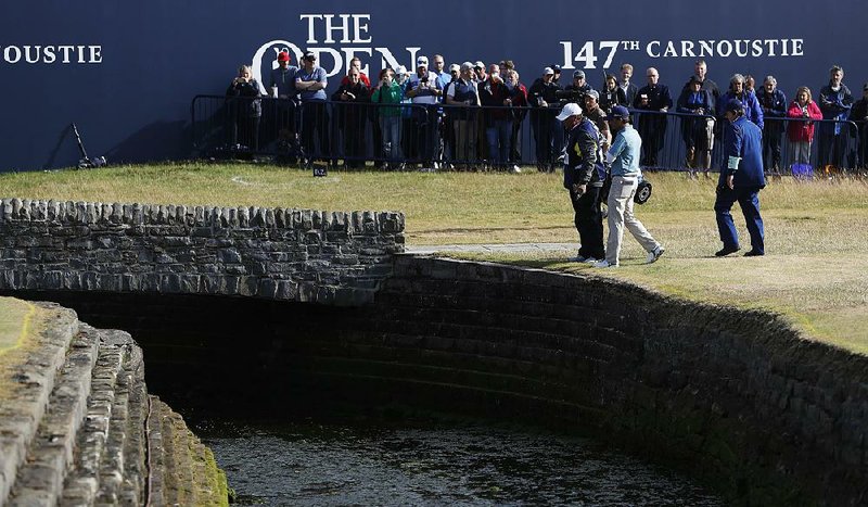 American Kevin Kisner talks with officials at the British Open on Friday after hitting a ball into the Barry Burn on the 18th hole at Carnoustie, Scotland. Kisner made a double bogey on the hole to finish with a 1-under 70 and a share of the lead. 