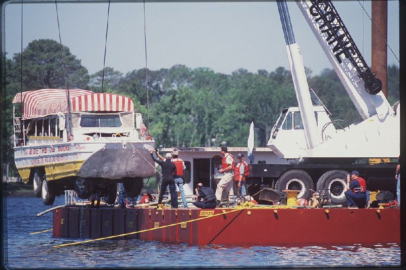 Investigators raise the duck boat that sank on May 1, 1999, in Hot Springs onto a barge in Lake Hamilton eight days later. Thirteen people died in the accident. The National Transportation and Safety Board ruled the boat’s owner failed to properly repair and maintain it.  