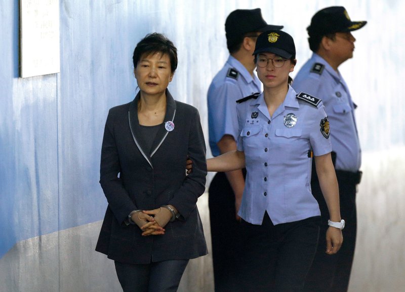 In this Aug. 7, 2017, file photo, former South Korean President Park Geun-hye, left, arrives for her trial at the Seoul Central District Court in Seoul. A South Korean court has sentenced on Friday, July 20, 2018, jailed Park to an additional eight years for abusing state funds and violating election laws. (AP Photo/Ahn Young-joon, File)