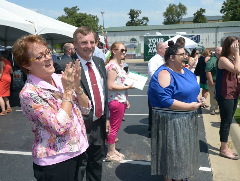 NWA Democrat-Gazette/ANDY SHUPE Evelyn Jorgenson (left), president of Northwest Arkansas Community College, applauds Friday alongside staff and community members during a groundbreaking for an Integrated Design Lab on the community college's campus in Bentonville. The 18,589-square-foot facility will be home to the construction technology and visual arts programs.
