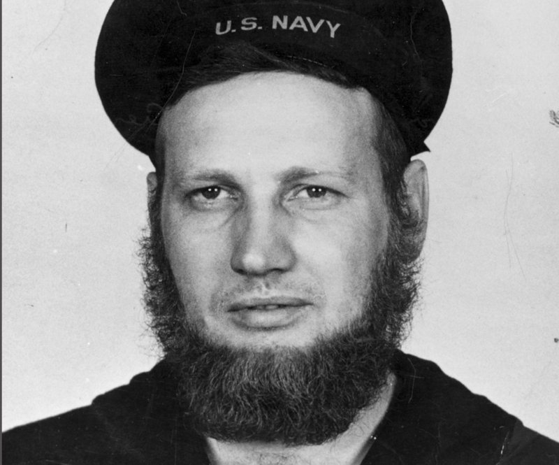 In this June 20, 1942 photo provided by the Naval History and Heritage Command, Howard Curtis, a U.S. Navy second-class aerographer, wears a seven-month's beard at Dutch Harbor, Alaska. Though the Navy said in July 2018, that its servicewomen could wear longer hairstyles, servicemen have not been permitted to wear beards, which were banned in 1984. (Naval History and Heritage Command via AP)