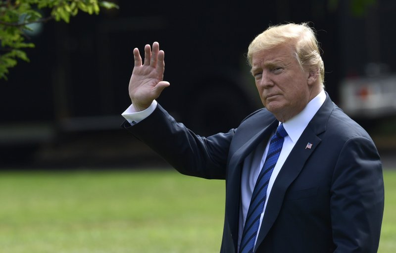 President Donald Trump waves as he walks across the South Lawn of the White House in Washington, Friday, July 20, 2018, to board Marine One for a short trip to Andrews Air Force Base, Md., en route to Bedminster N.J., for the weekend. (AP Photo/Susan Walsh)