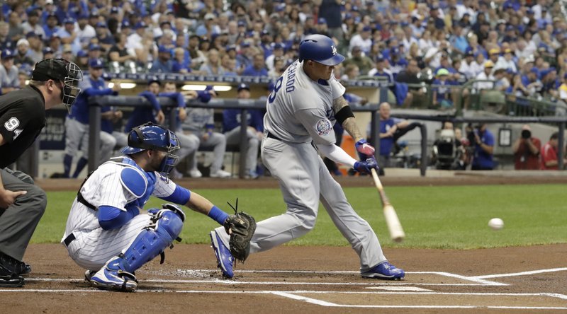 Los Angeles Dodgers' Manny Machado hits a single during the first inning of a baseball game against the Milwaukee Brewers Friday, July 20, 2018, in Milwaukee. (AP Photo/Morry Gash)