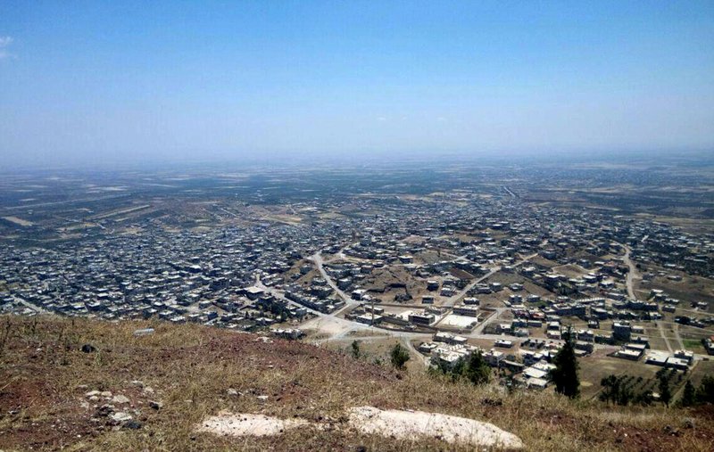 This photo released Tuesday, July 17, 2018, by the Syrian official news agency SANA, shows a general view of Tell al-Haara, from the highest hill in the southwestern Daraa province, Syria.  (SANA via AP)