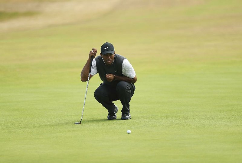 Tiger Woods of the US lines up a putt on the 9th green during the third round of the British Open Golf Championship in Carnoustie, Scotland, Saturday July 21, 2018. 